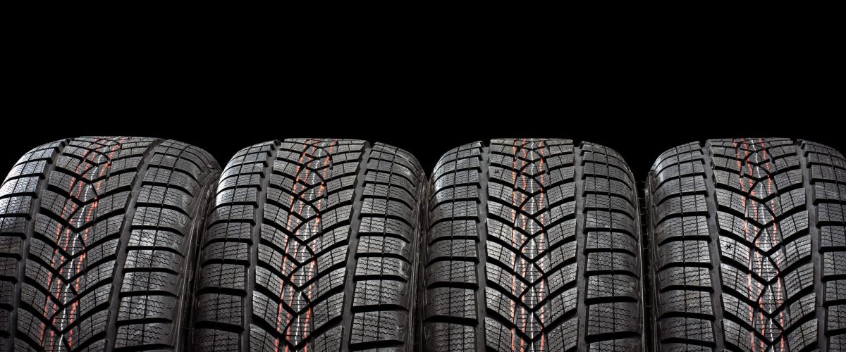 four-winter-tires-standing-on-black-background-XTMDDJN four-winter-tires-standing-on-black-background-XTMDDJN